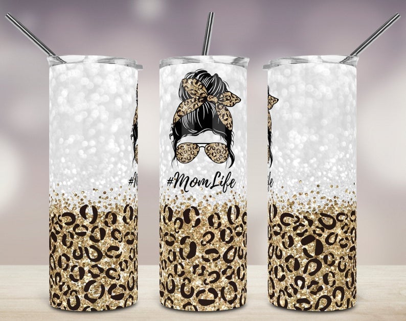 20oz skinny tumbler with gold glitter leopard print, Mom Life graphic, messy bun hairstyle, leopard sunglasses, and matching gold bandana.