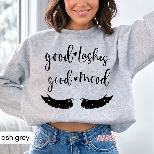 Ash grey sweatshirt with the Good Lashes Good Mood design and eyelash graphic, perfect for licensed lash technicians, estheticians, and salon staff.
