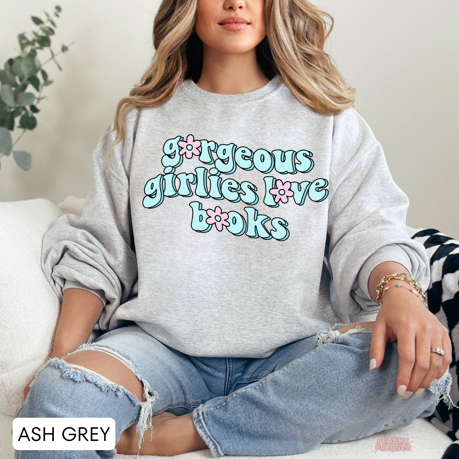 Ash Grey crewneck sweatshirt featuring the "Gorgeous Girlies Love Books" retro graphic in pastel blue and pink typography.