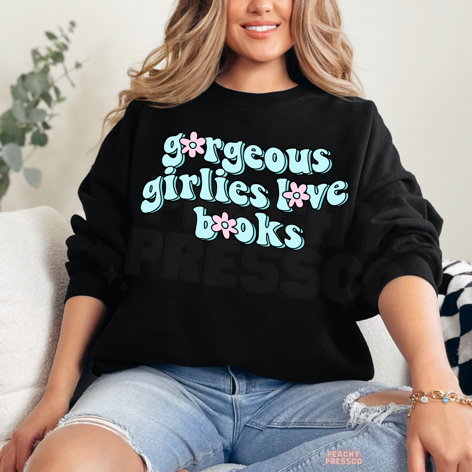Black crewneck sweatshirt featuring the "Gorgeous Girlies Love Books" graphic in pastel retro lettering for cozy reading days.