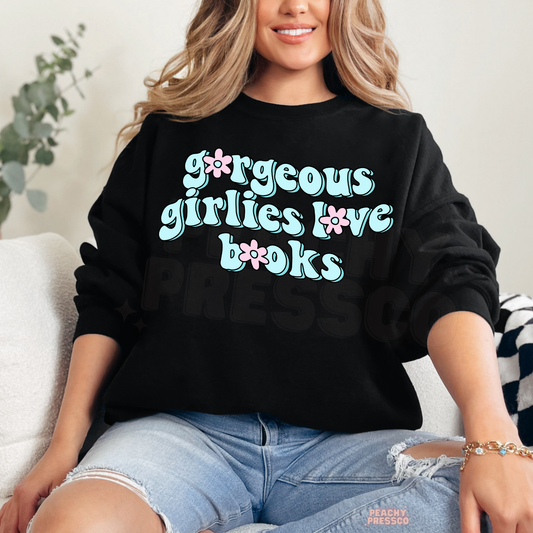 Black crewneck sweatshirt featuring the "Gorgeous Girlies Love Books" graphic in pastel retro lettering for cozy reading days.