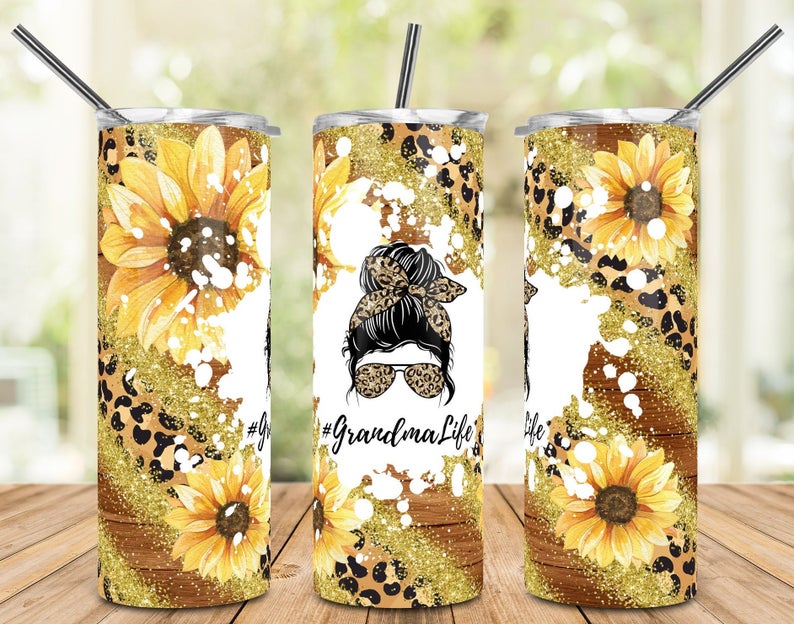 20oz skinny tumbler featuring sunflowers, leopard print, glitter, and Grandma Life messy bun design.