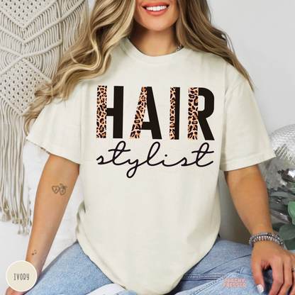 Ivory unisex t-shirt with a modern leopard print Hair Stylist graphic, a stylish gift for hairstylists, salon owners, beauty professionals, and cosmetologists.