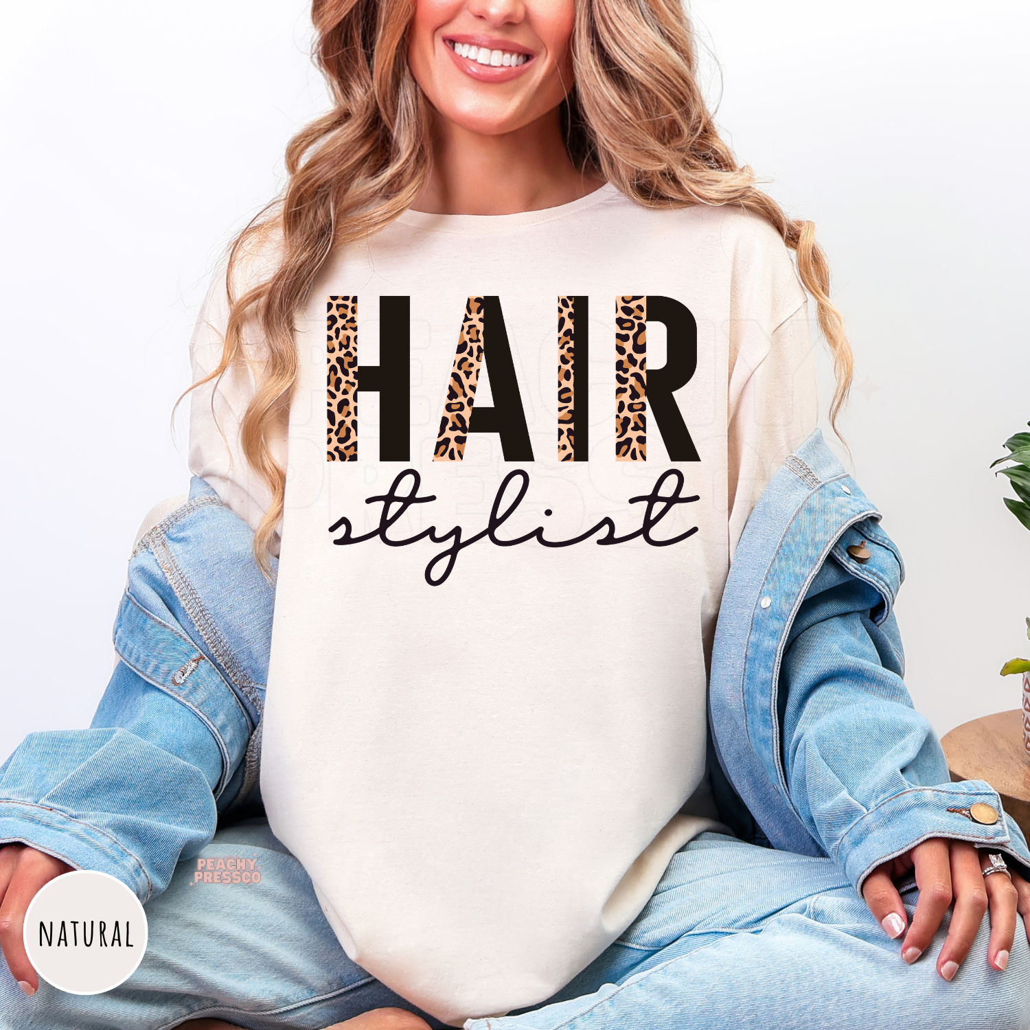 Natural shirt with a bold leopard print Hair Stylist graphic, an ideal gift for hairstylists, salon owners, cosmetology students, and hairdressers.