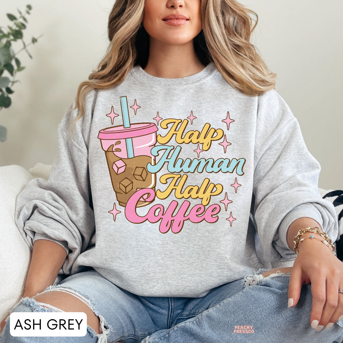Ash grey Half Human Half Coffee sweatshirt featuring a colourful iced coffee illustration and playful retro coffee lettering.