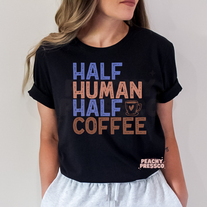 Black graphic t-shirt featuring the funny "Half Human Half Coffee" quote with a coffee cup illustration in retro distressed lettering.