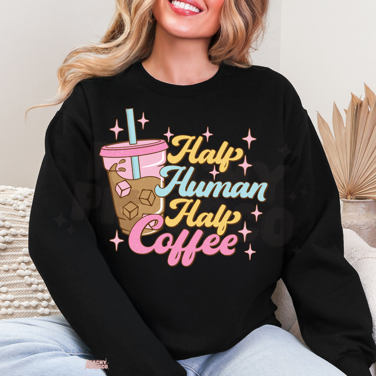 Black Half Human Half Coffee sweatshirt with a vibrant retro coffee graphic, iced coffee cup and pink sparkles.