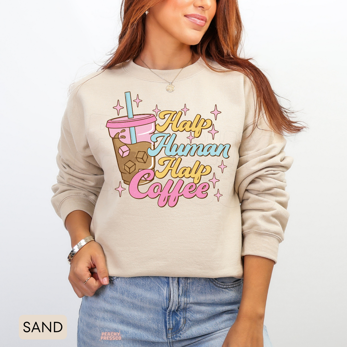 Sand Half Human Half Coffee sweatshirt with a retro iced coffee cup, pastel lettering and pink sparkle accents.
