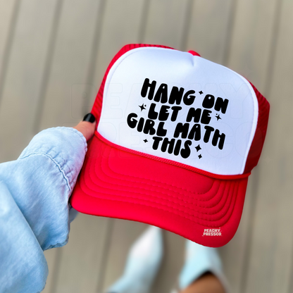 Red and white foam trucker hat featuring the funny "Hang On Let Me Girl Math This" saying in bold black lettering. Cute trendy women's baseball cap for vacations, girls' trips, shopping, and everyday style.