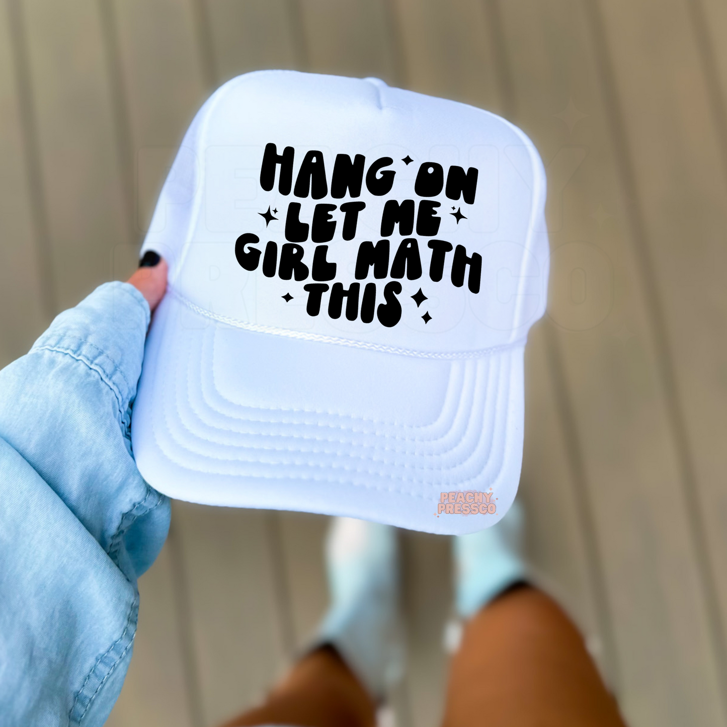 White foam trucker hat featuring the funny phrase "Hang On Let Me Girl Math This" in bold black lettering with sparkles. Trendy women's trucker hat perfect for shopping, errands, vacations, and everyday wear.