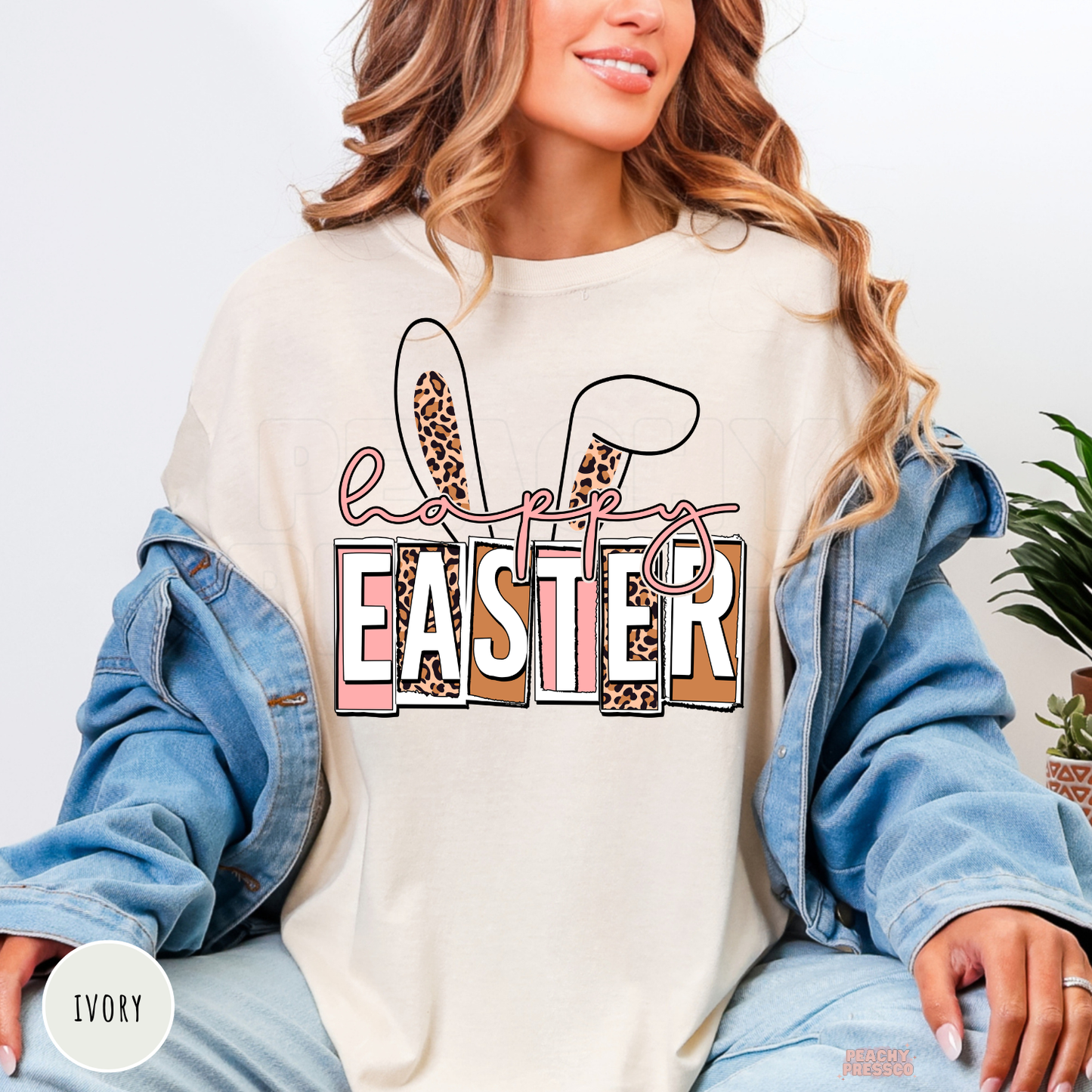 Ivory shirt featuring a trendy Happy Easter bunny ears graphic with leopard print details.