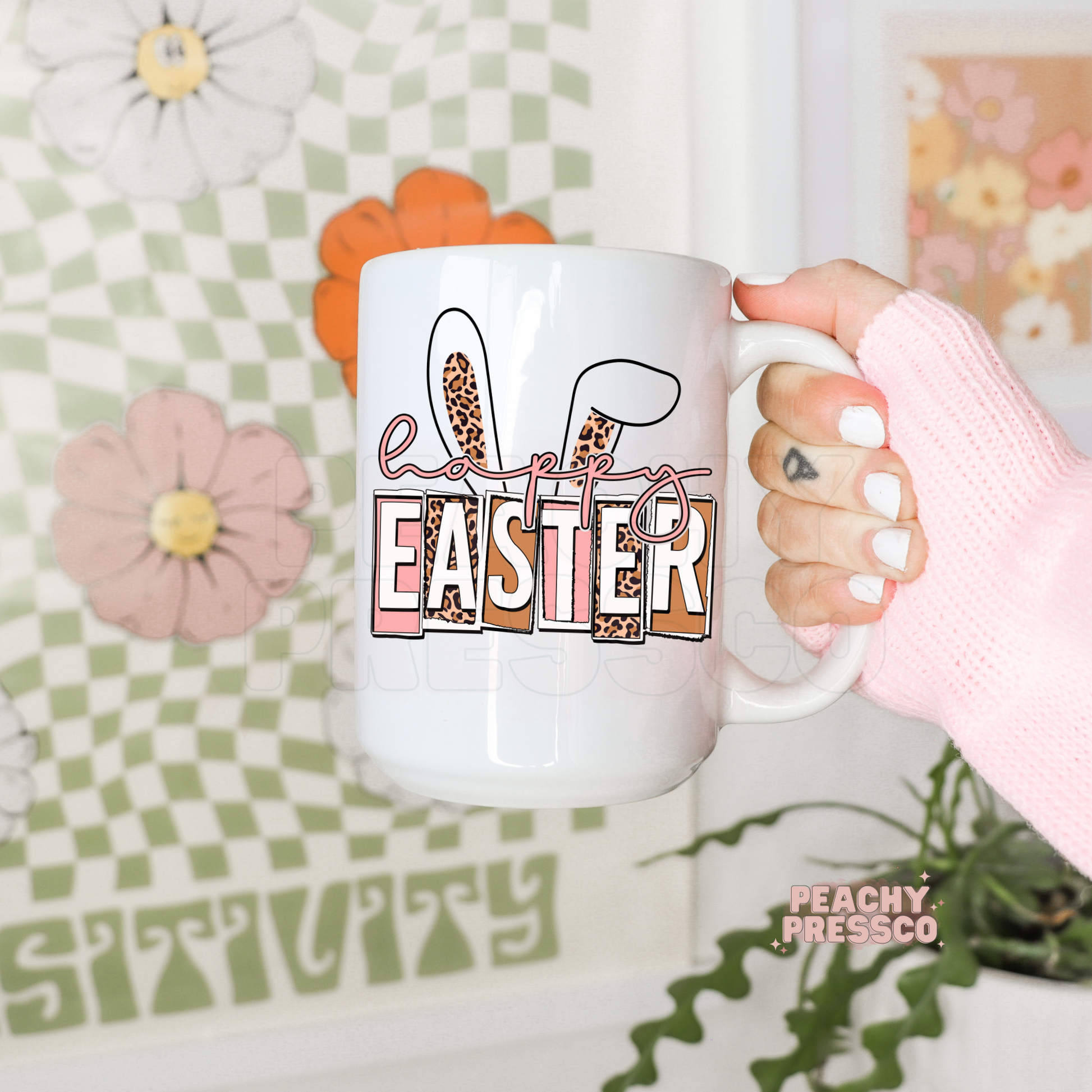 White ceramic Easter mug with leopard print bunny ears, retro Happy Easter lettering, and soft pink spring colors.