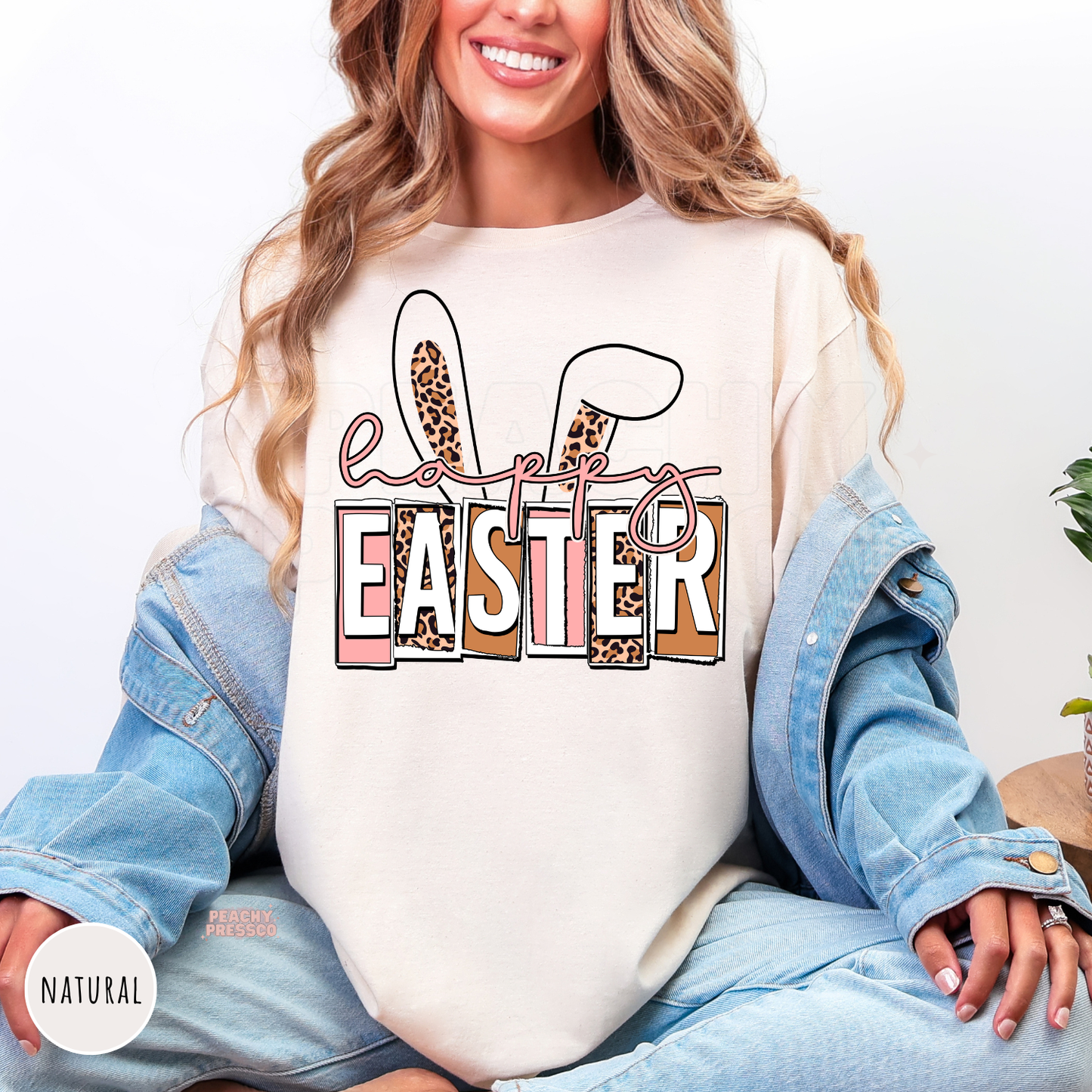 Natural shirt featuring a stylish Happy Easter design with leopard bunny ears and pink typography.