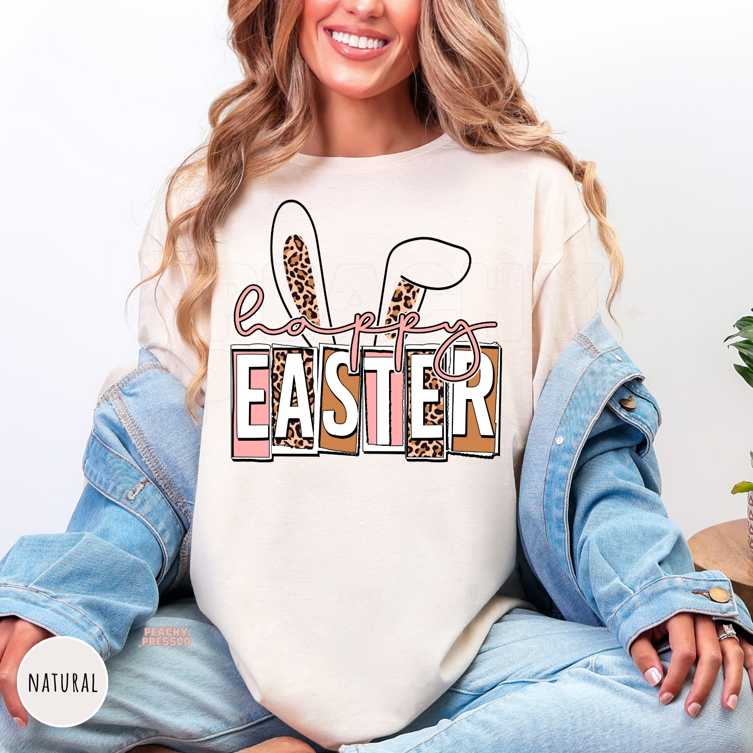 Natural shirt featuring a stylish Happy Easter design with leopard bunny ears and pink typography.