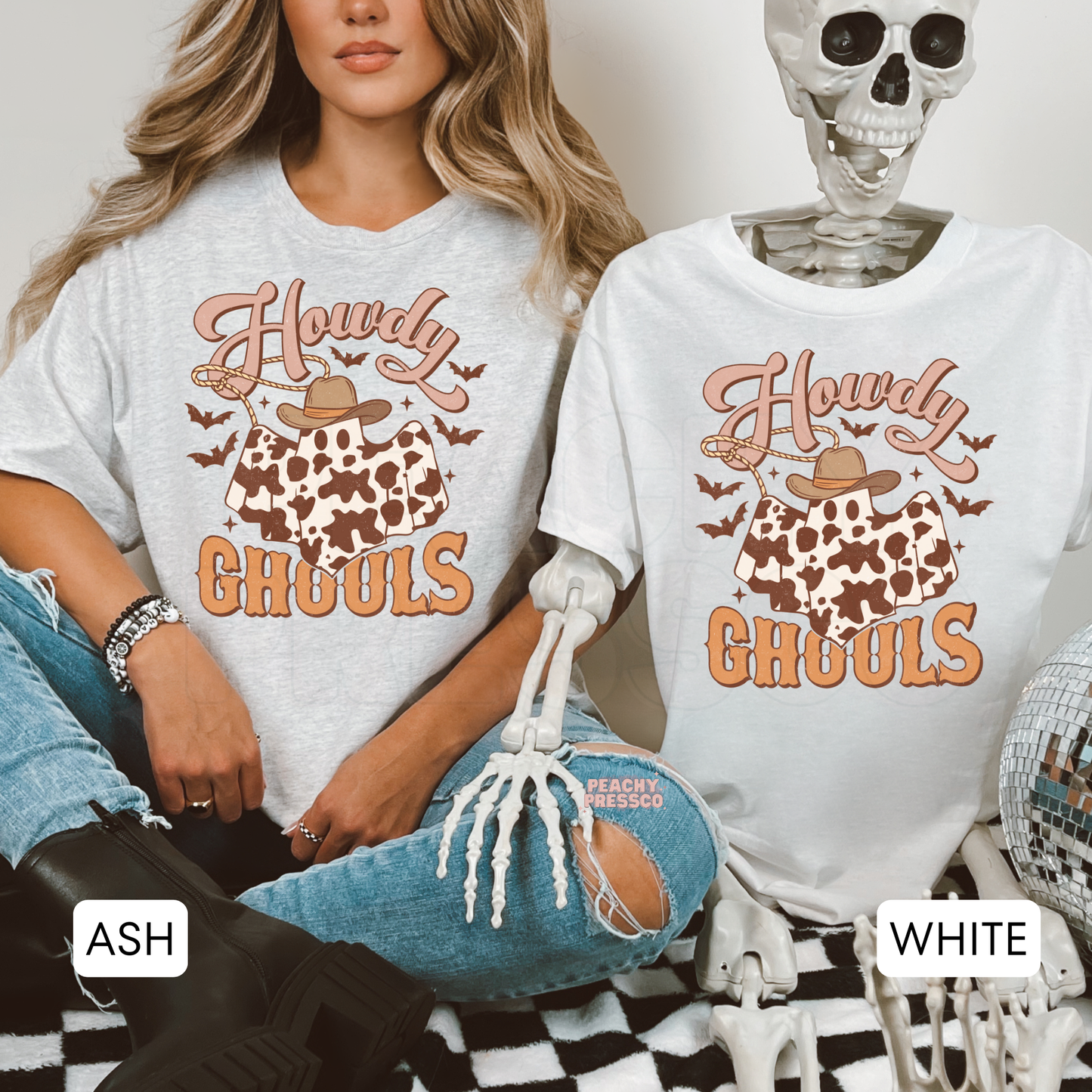 Side-by-side ash grey and white Halloween t-shirts featuring the Howdy Ghouls cowboy ghost graphic with cow print and western fall design.