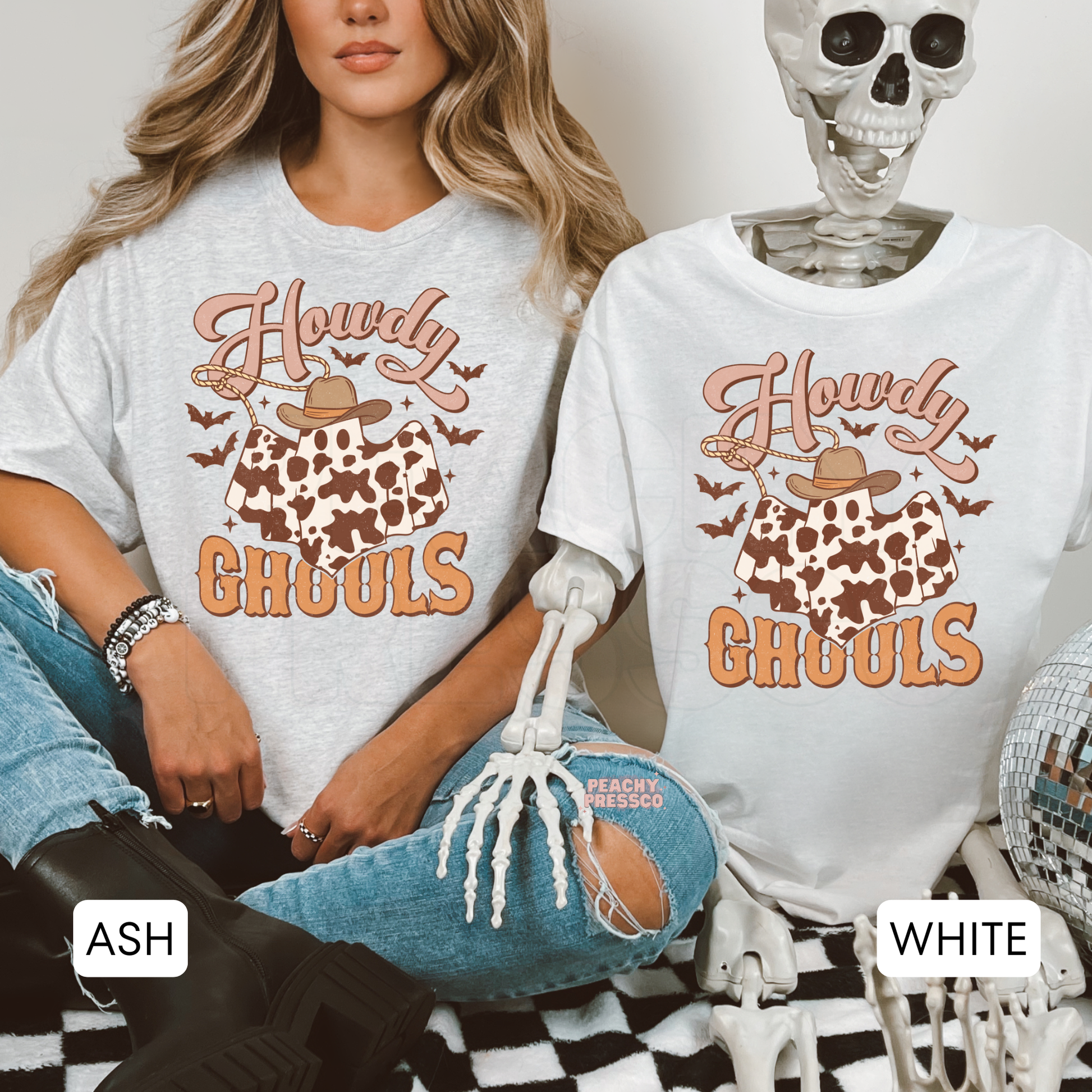 Side-by-side ash grey and white Halloween t-shirts featuring the Howdy Ghouls cowboy ghost graphic with cow print and western fall design.