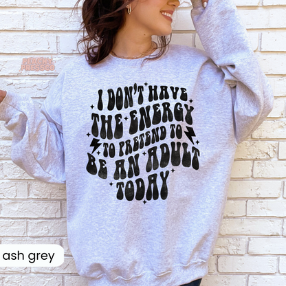 Ash grey crewneck sweatshirt displaying the humorous quote "I Don't Have the Energy to Pretend to Be an Adult Today" in bold retro black lettering.