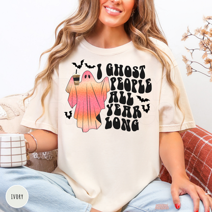 Ivory Halloween shirt with I Ghost People All Year Long design featuring a pink ghost holding coffee and black bats
