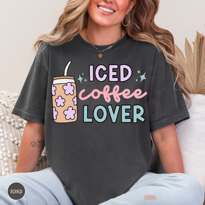 Pepper Iced Coffee Lover graphic t-shirt featuring pastel pink script, lavender flowers, teal lettering and a cute iced coffee tumbler.