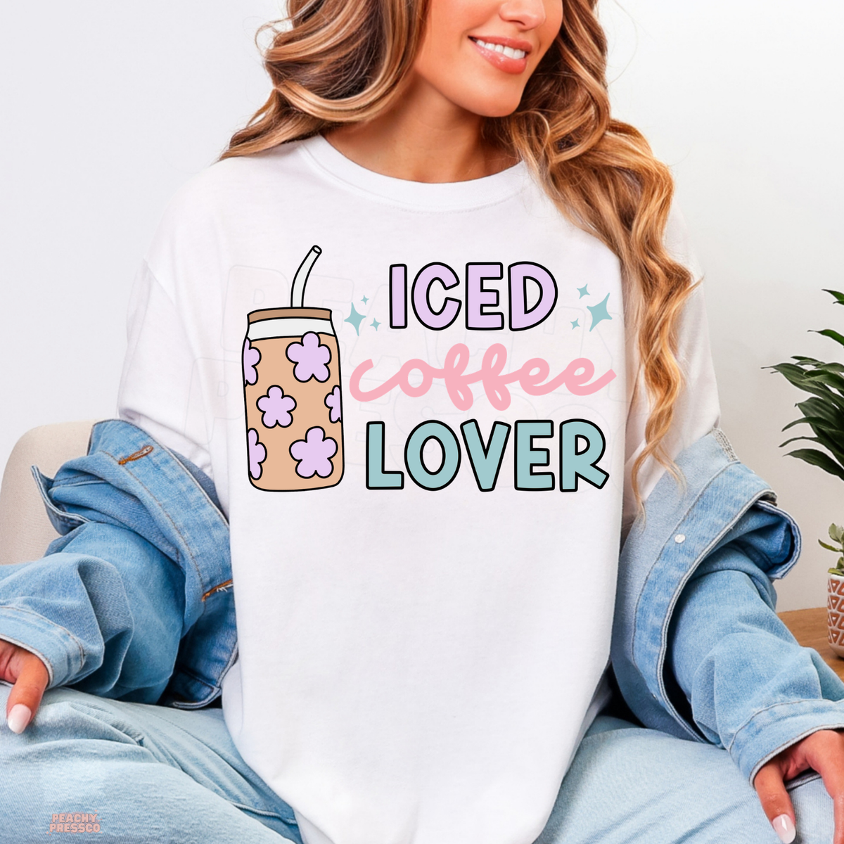 White Iced Coffee Lover shirt featuring a pastel floral iced coffee tumbler with pink, lavender and teal typography.