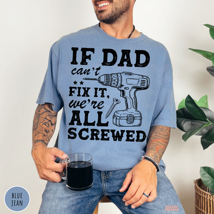 Blue Jean garment-dyed t-shirt featuring the white "If Dad Can't Fix It, We're All Screwed" design with a cordless drill and screw graphic. Funny Father's Day gift for DIY dads and woodworking enthusiasts.