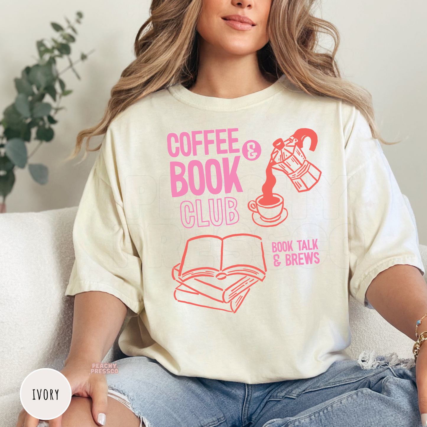 Ivory Comfort Colors t-shirt with a retro "Coffee & Book Club" graphic featuring books, fresh coffee, and "Book Talk & Brews" typography in soft pink and coral.