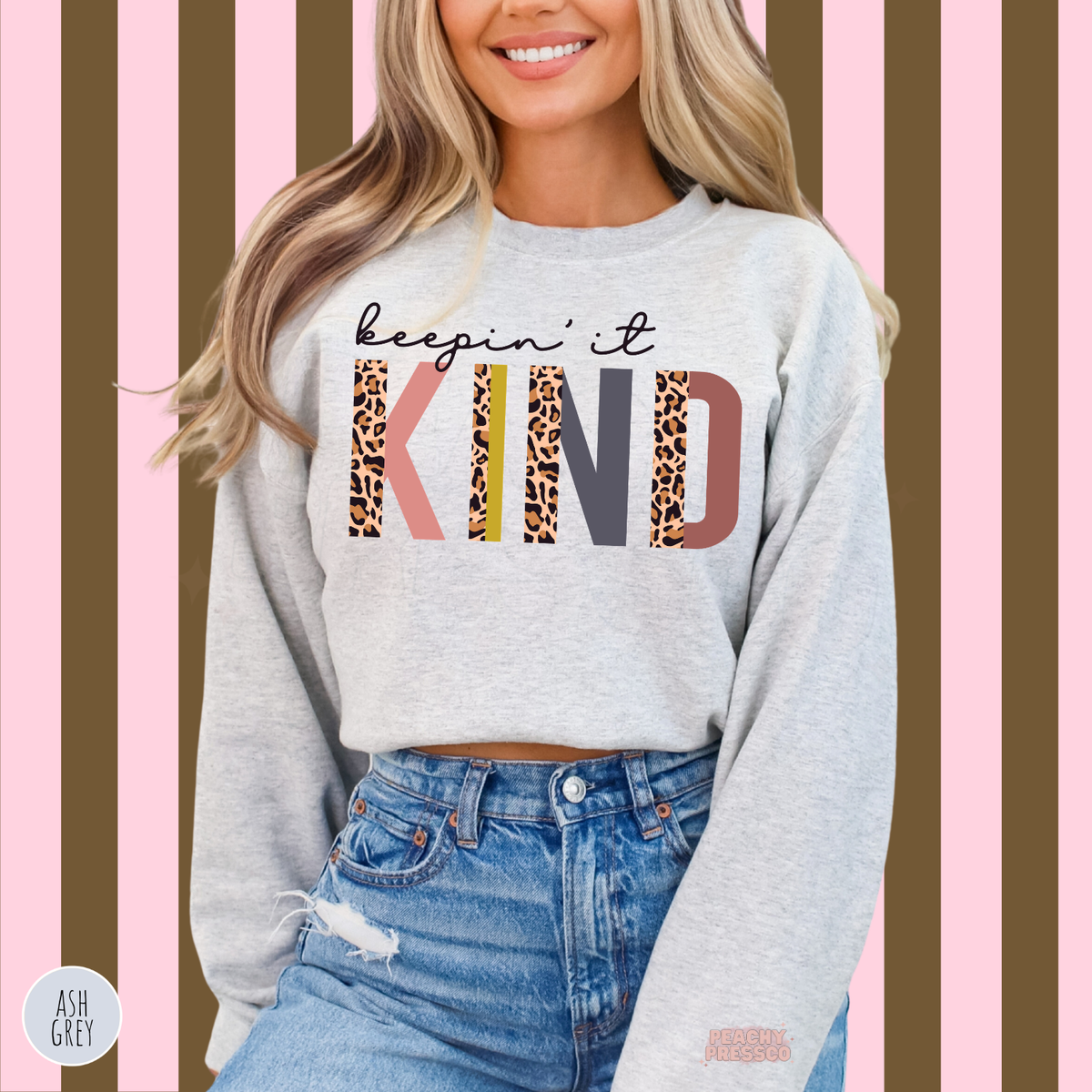 Ash grey Keepin' It Kind sweatshirt featuring oversized colorful KIND lettering, trendy leopard print accents and a positive kindness message.