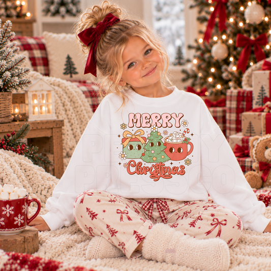 Girl wearing a white kids Christmas crewneck with a cute retro Merry Christmas tree, present and hot cocoa graphic.