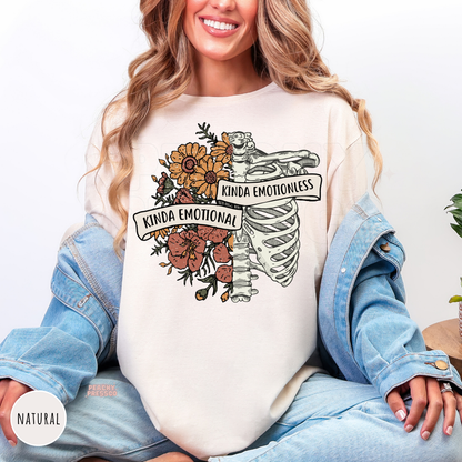 Natural t-shirt displaying a vintage botanical skeleton graphic with "Kinda Emotional Kinda Emotionless," perfect for alternative, boho, and mental health-inspired fashion.