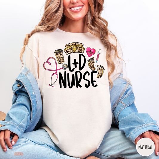 Natural L&D nurse shirt featuring leopard print baby footprints, nurse hat, pink heart stethoscope, syringe and coffee cup.