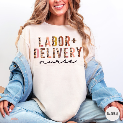 Natural shirt with Labor + Delivery nurse lettering in pink, peach and leopard print, modeled with light blue jeans and a denim jacket.