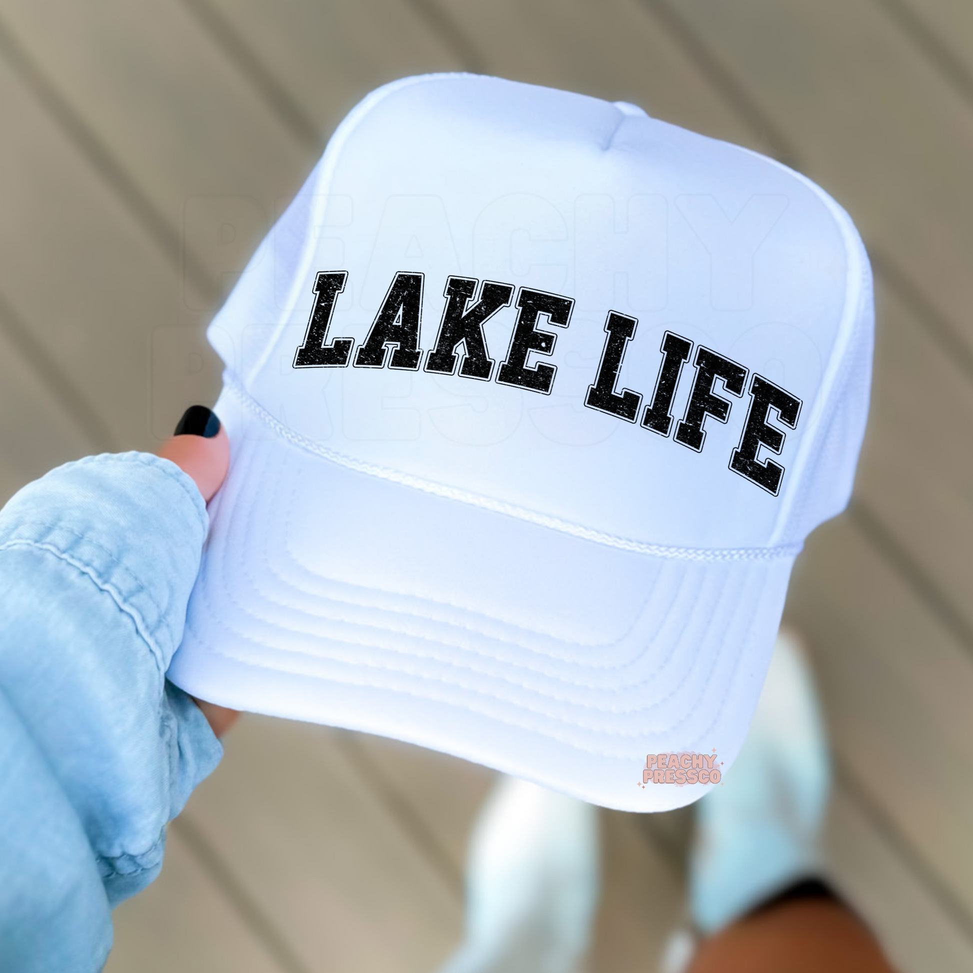 White foam trucker hat featuring distressed "LAKE LIFE" varsity lettering, perfect for lake days, boating, cottage weekends, summer vacations, and outdoor adventures.