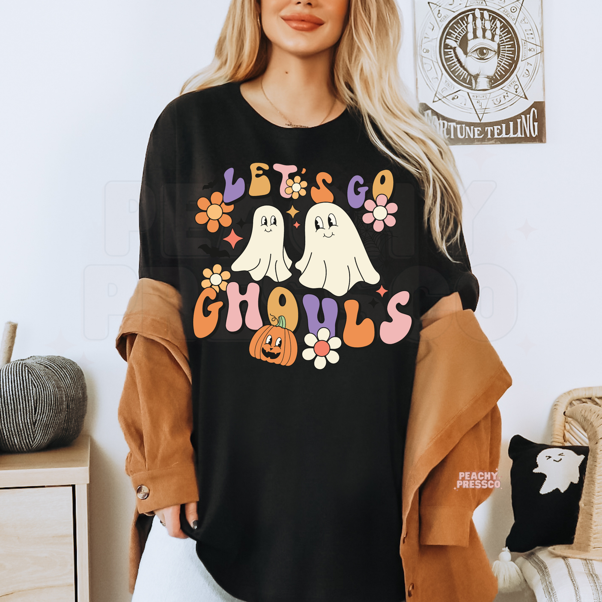 Black Let’s Go Ghouls Halloween T-shirt featuring two cute ghosts with retro orange, pink and purple Halloween details
