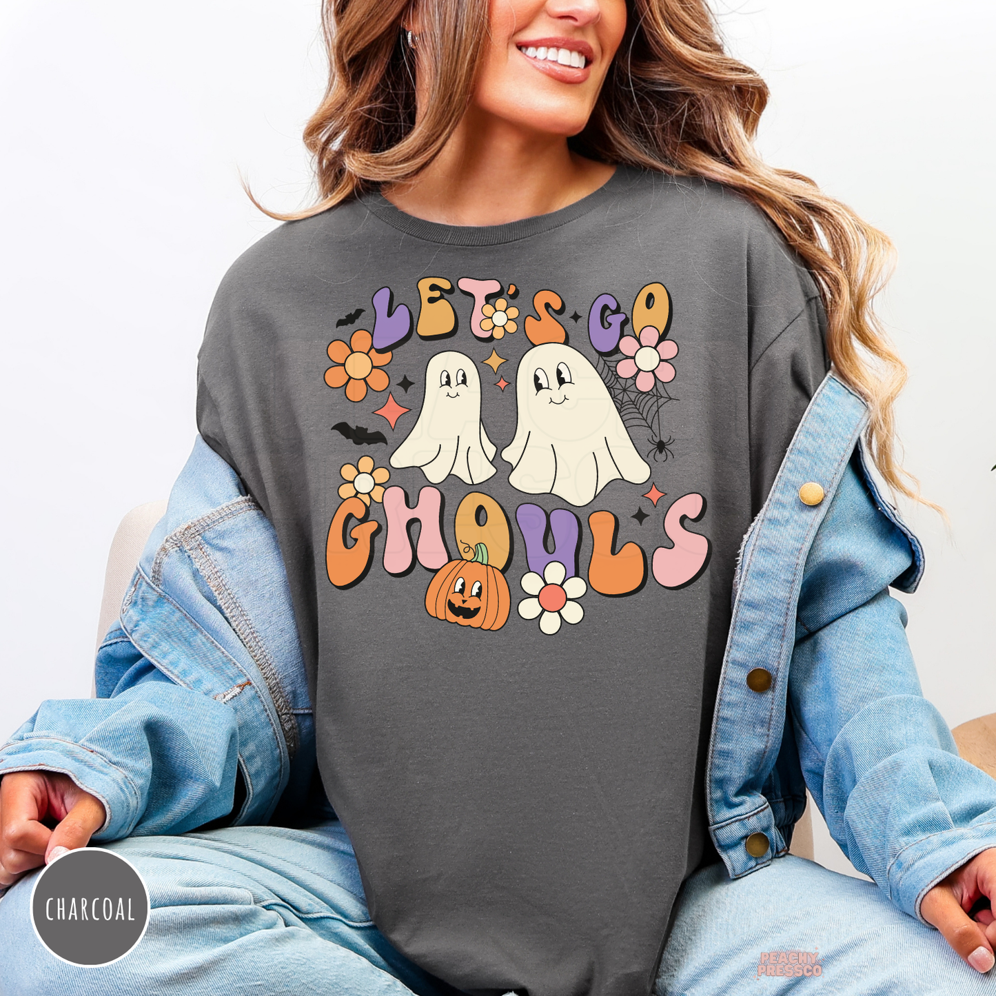 Charcoal Let’s Go Ghouls Halloween shirt featuring cute ghosts, pumpkin, bats and colorful retro groovy flowers