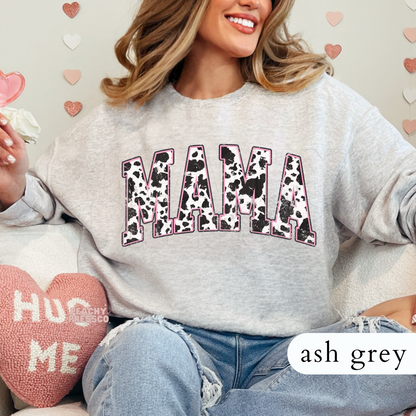 Ash Grey sweatshirt featuring a distressed cow print "MAMA" graphic with soft pink outline. Perfect gift for moms who love western and trendy styles.