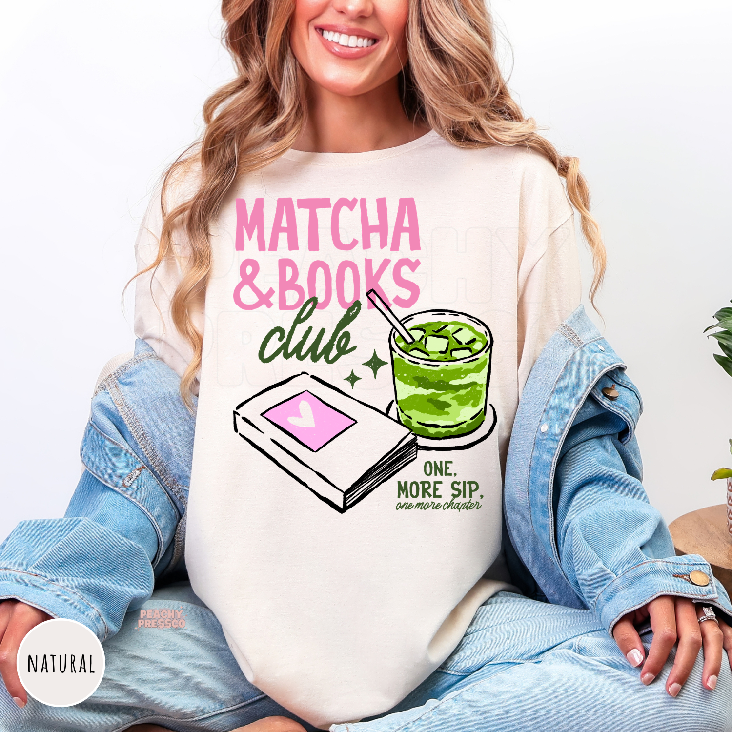 Woman wearing a natural Comfort Colors t-shirt featuring the Matcha & Books Club graphic with a green iced matcha, illustrated book, and reading-inspired design. Relaxed oversized tee for readers and matcha lovers.