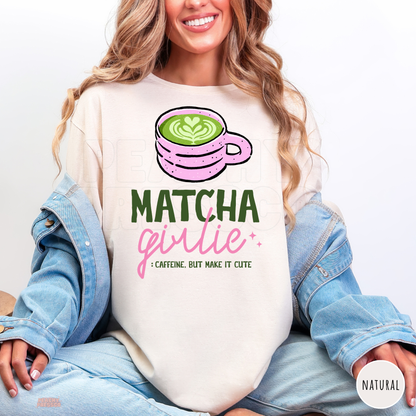 Natural Matcha Girlie shirt featuring a pink matcha latte cup with green heart latte art, pink lettering, and Caffeine But Make It Cute quote.