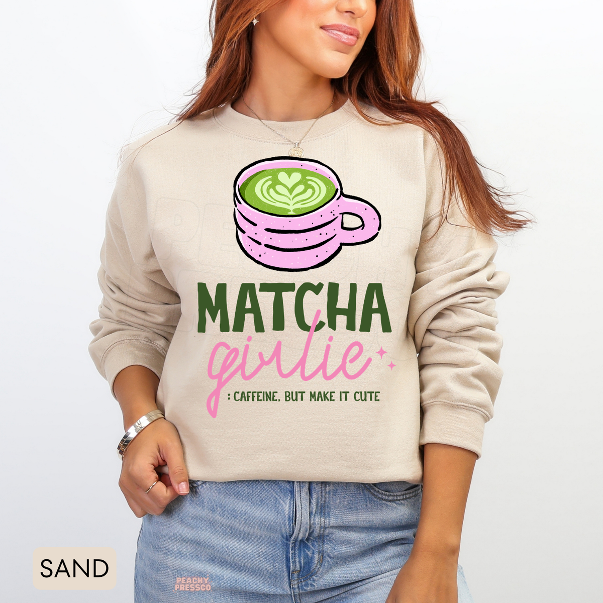 Sand Matcha Girlie sweatshirt displaying a pink matcha cup with green latte art, pink sparkles, and Caffeine But Make It Cute graphic.