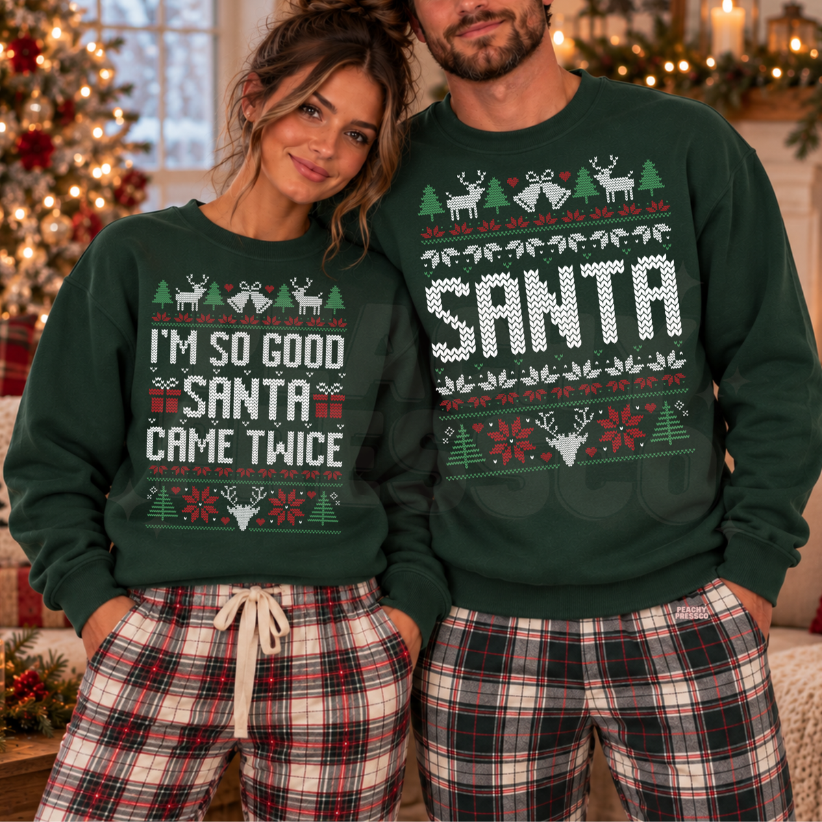 A couple wearing matching forest green Christmas sweaters with festive holiday graphics and text, paired with red and black plaid pajama pants, posed in front of a decorated Christmas tree and warm holiday lights.