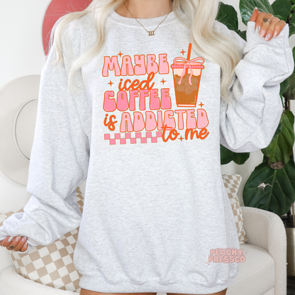 Ash grey crewneck sweatshirt featuring the playful "Maybe Iced Coffee Is Addicted to Me" graphic with a pink iced coffee illustration.