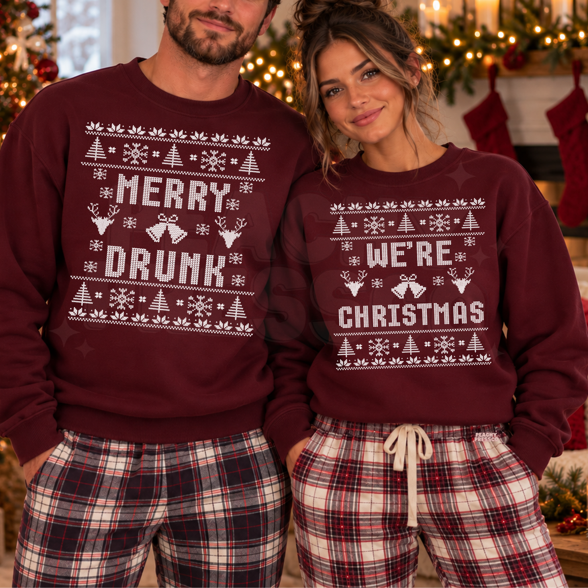 A man and a woman wearing matching burgundy Christmas sweatshirts with white festive graphics. The man's sweatshirt reads 'MERRY DRUNK' and the woman's reads 'WE'RE CHRISTMAS'.