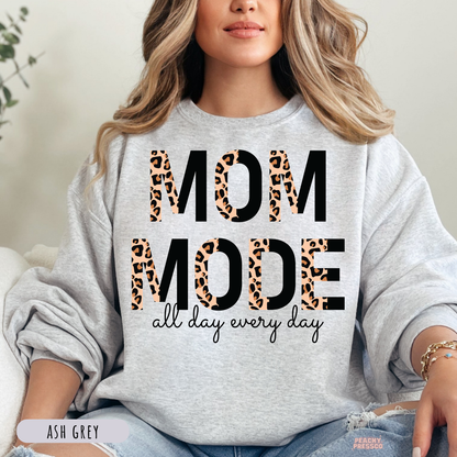 Ash Grey sweatshirt featuring a bold "Mom Mode All Day Every Day" leopard print graphic. Stylish funny mom crewneck sweatshirt.