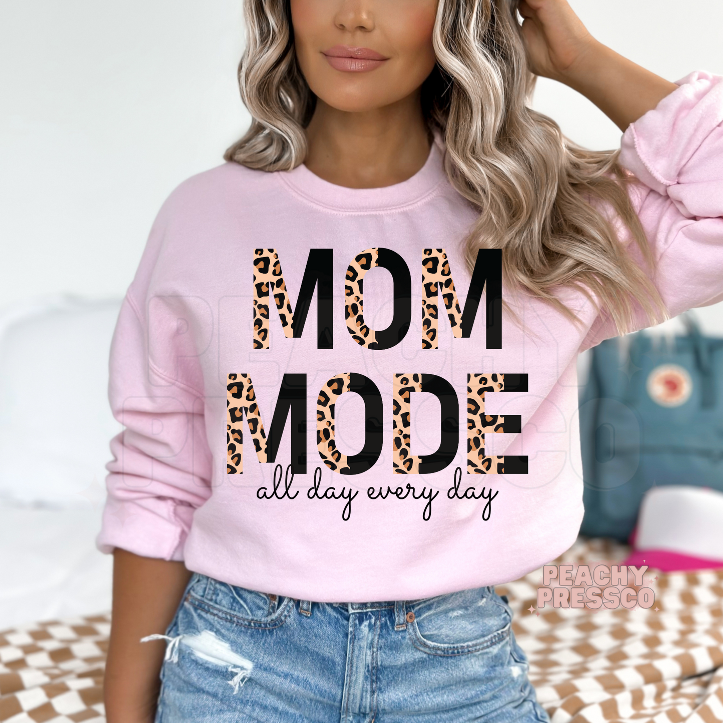 Light pink sweatshirt featuring a stylish "Mom Mode All Day Every Day" leopard print design. Cute mom sweatshirt for busy moms.
