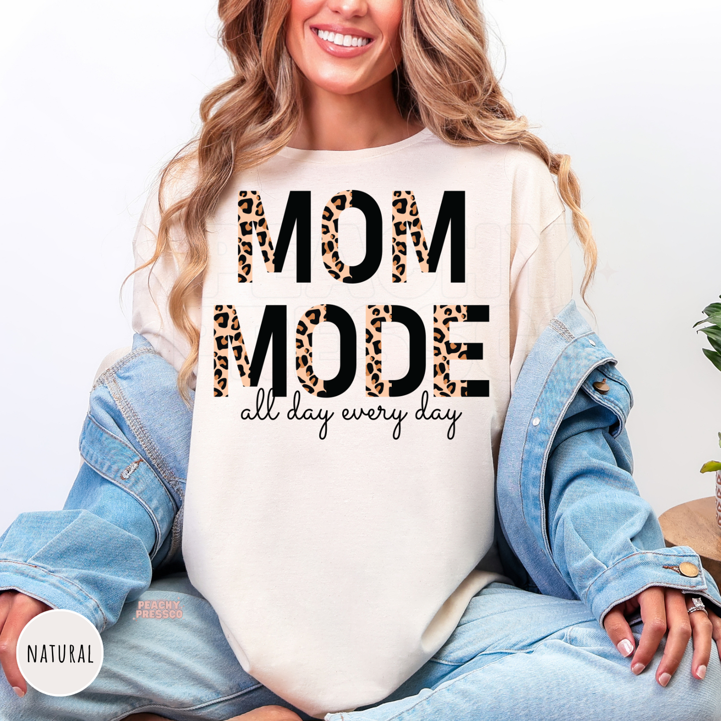 Natural shirt featuring a bold leopard print "Mom Mode All Day Every Day" graphic. Comfortable everyday mom apparel.