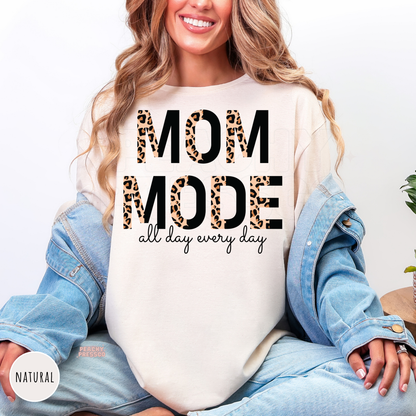 Natural shirt featuring a bold leopard print "Mom Mode All Day Every Day" graphic. Comfortable everyday mom apparel.