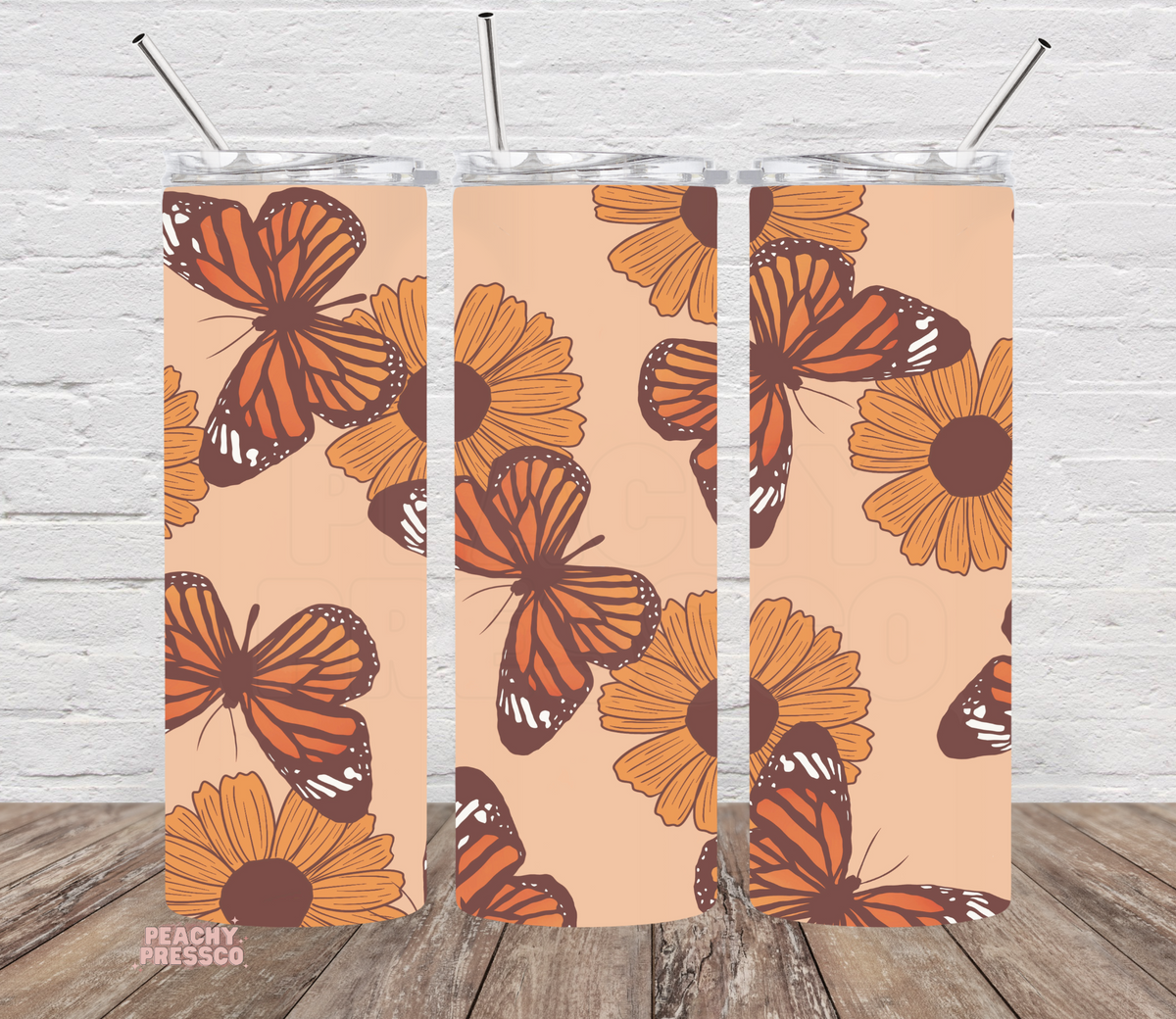 20 oz skinny tumbler featuring vintage monarch butterflies and orange wildflowers on a neutral background. Perfect floral tumbler for nature lovers.