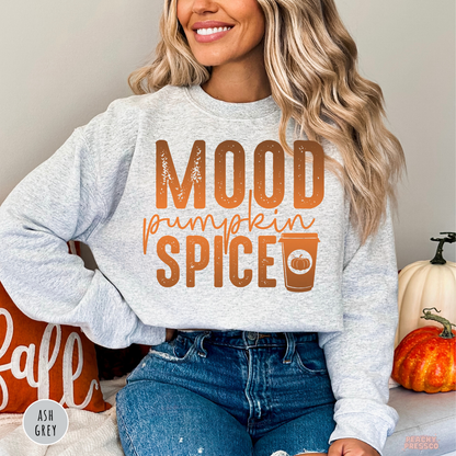 Woman wearing an ash grey crewneck sweatshirt with a trendy "Mood Pumpkin Spice" graphic and pumpkin spice coffee cup for fall.