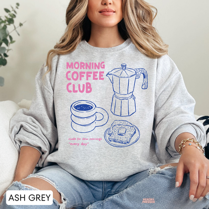 Ash grey Morning Coffee Club sweatshirt featuring pink typography, blue coffee maker, coffee cup and breakfast toast illustrations.
