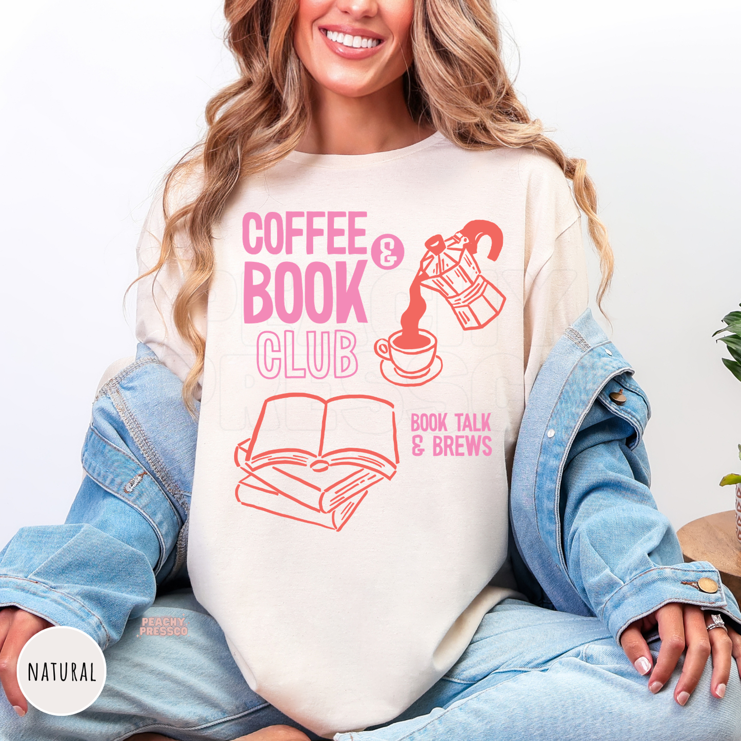 Natural cream graphic t-shirt featuring a "Coffee & Book Club" design with stacked books, a coffee cup, and moka pot illustration in pink and coral for book lovers.