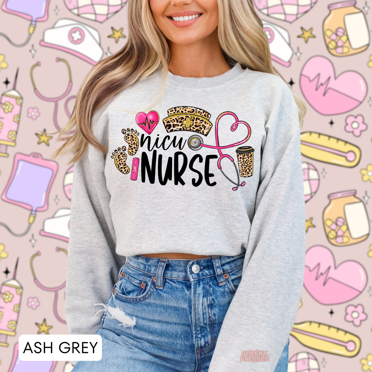 Ash grey NICU nurse sweatshirt with leopard baby footprints, pink heartbeat heart, leopard nurse hat and pink heart-shaped stethoscope.